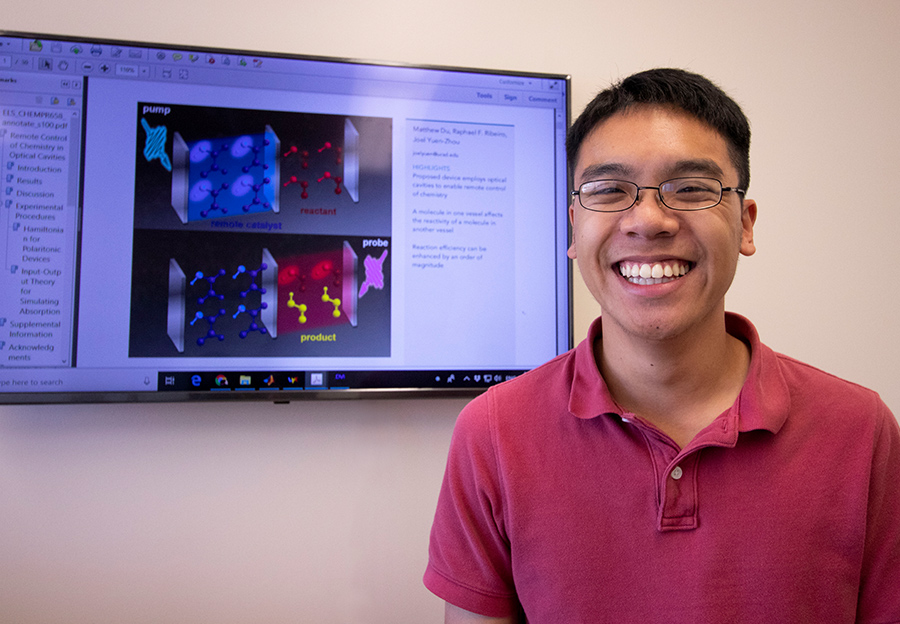 Matthew Du pictured if front of a presentation slide displaying the theoretical model of the two optical cavities. Photo by Michelle Fredricks, UC San Diego Physical Sciences