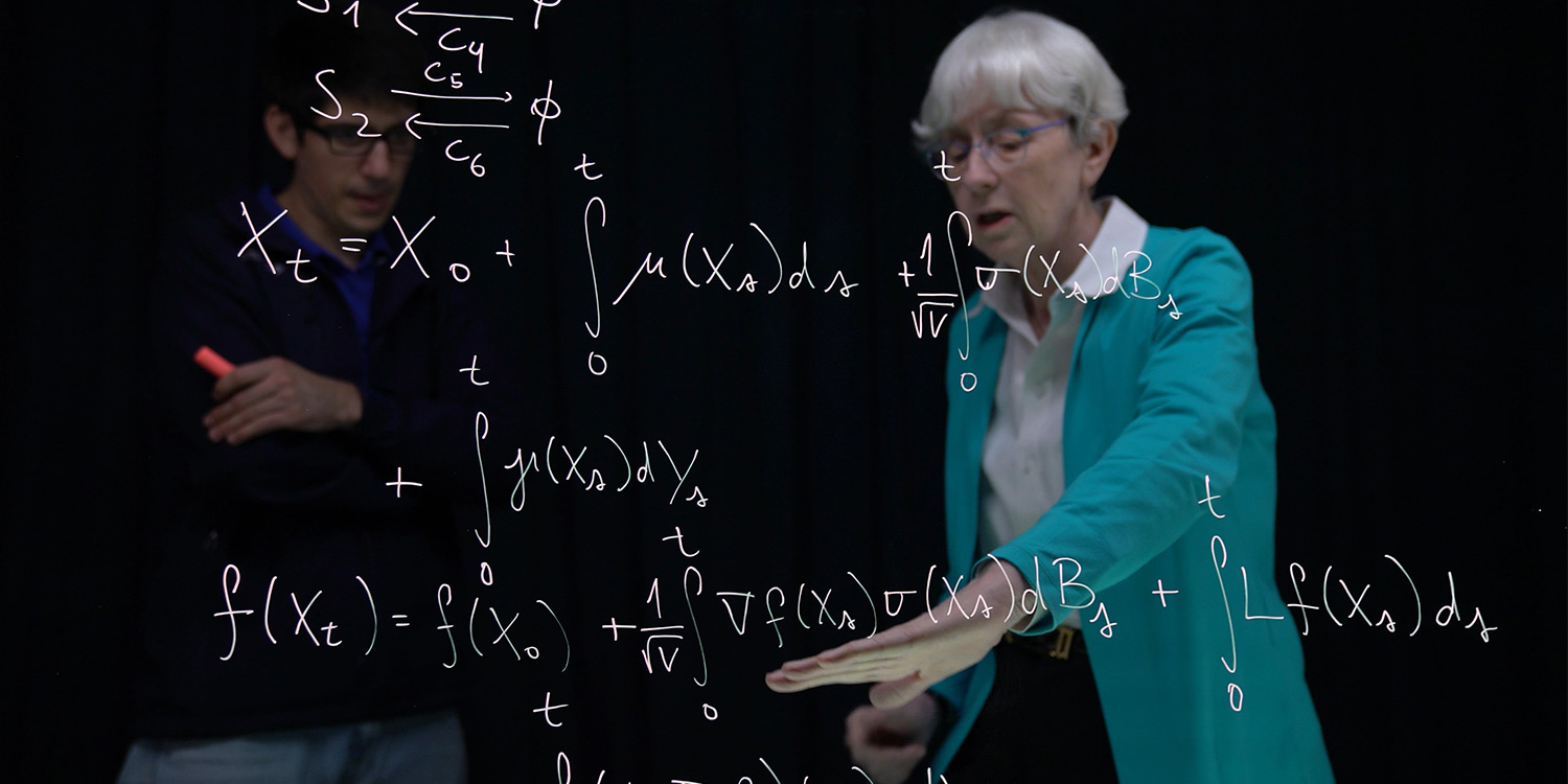 Ph.D. student, Felipe Campos-vergara, discussing a stochastic model for chemical reactions with Professor Williams. Image courtesy of UC San Diego Publications