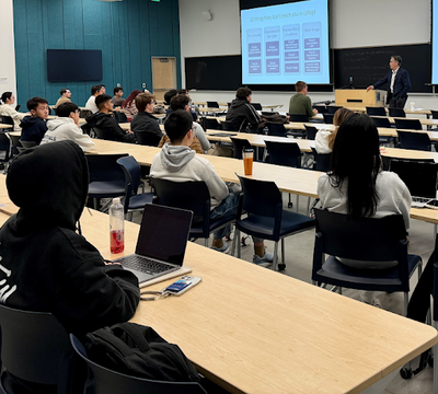 Students listening to an alumni speaker 