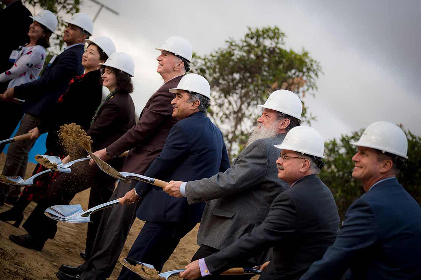 People with shovels at a groundbreaking ceremony