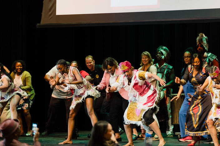 Attendees dancing on stage.