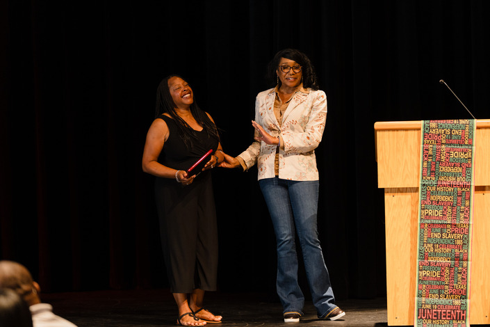 Barbara Jackson being awarded on stage.