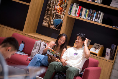 Students reading on a couch in the library.