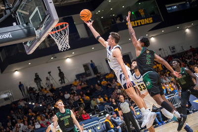 UC San Diego students playing basketball in LionTree Arena.