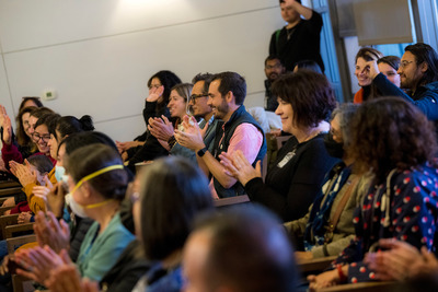 Attendees applaud in support during the showcase.
