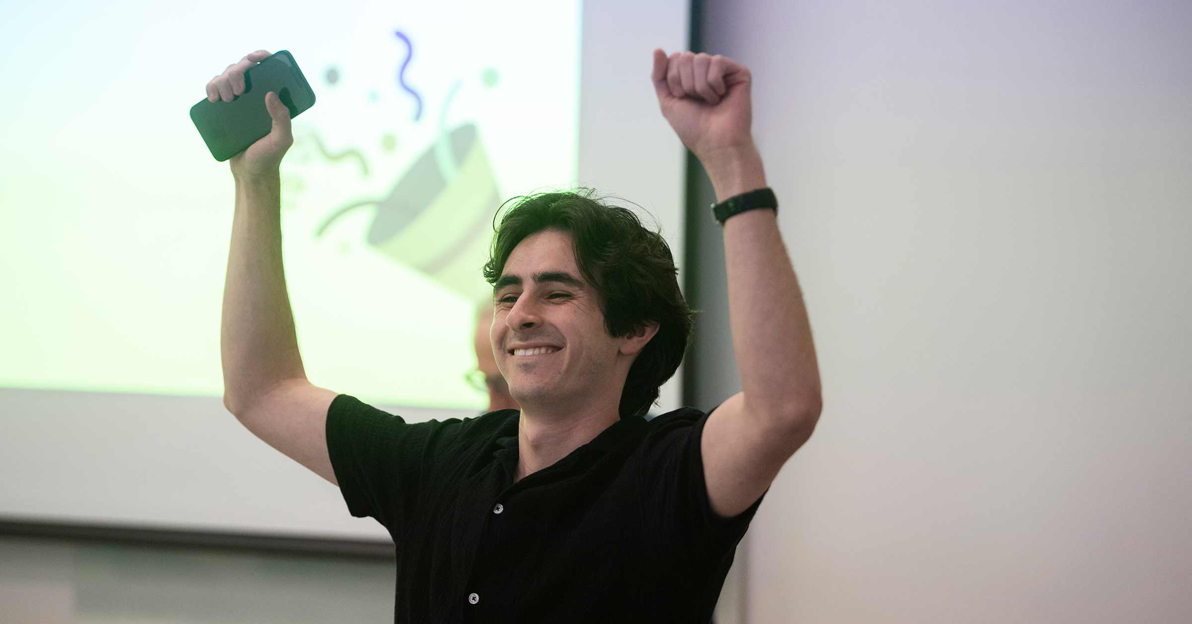 Speech and Debate student celebrates by pumping both hands in air