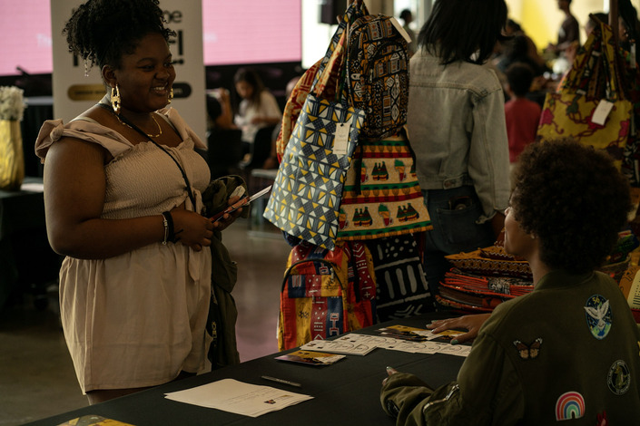 Shoppers browse a booth.