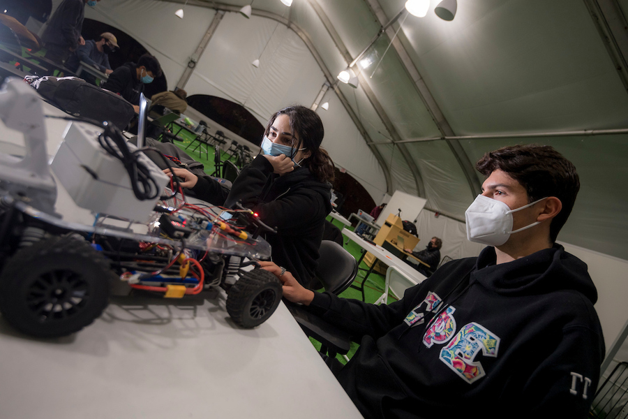 Engineering students working on robotic cars.