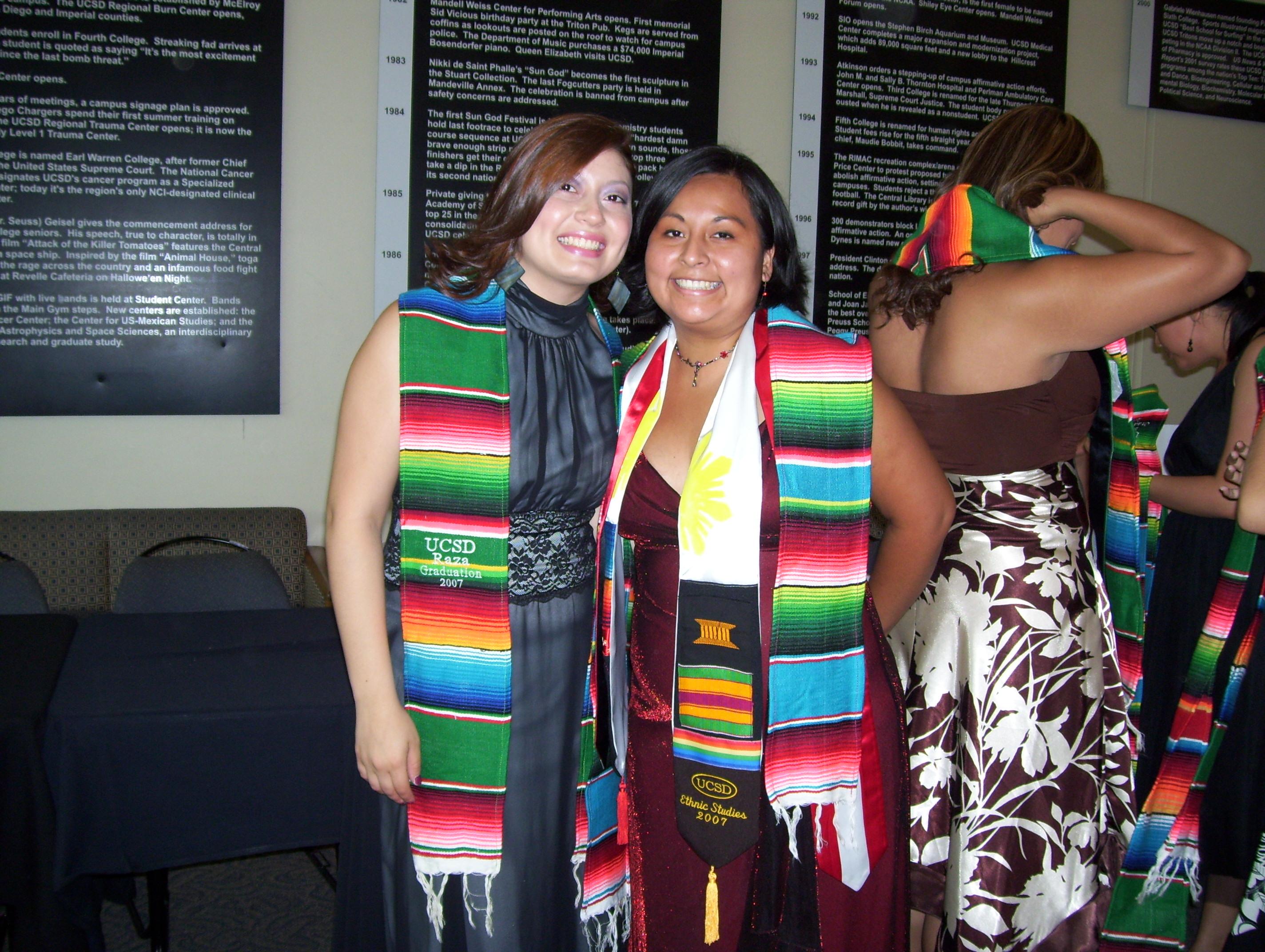 Two people standing next to each other, both wearing colored stoles