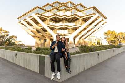 A couple smile at Geisel Library