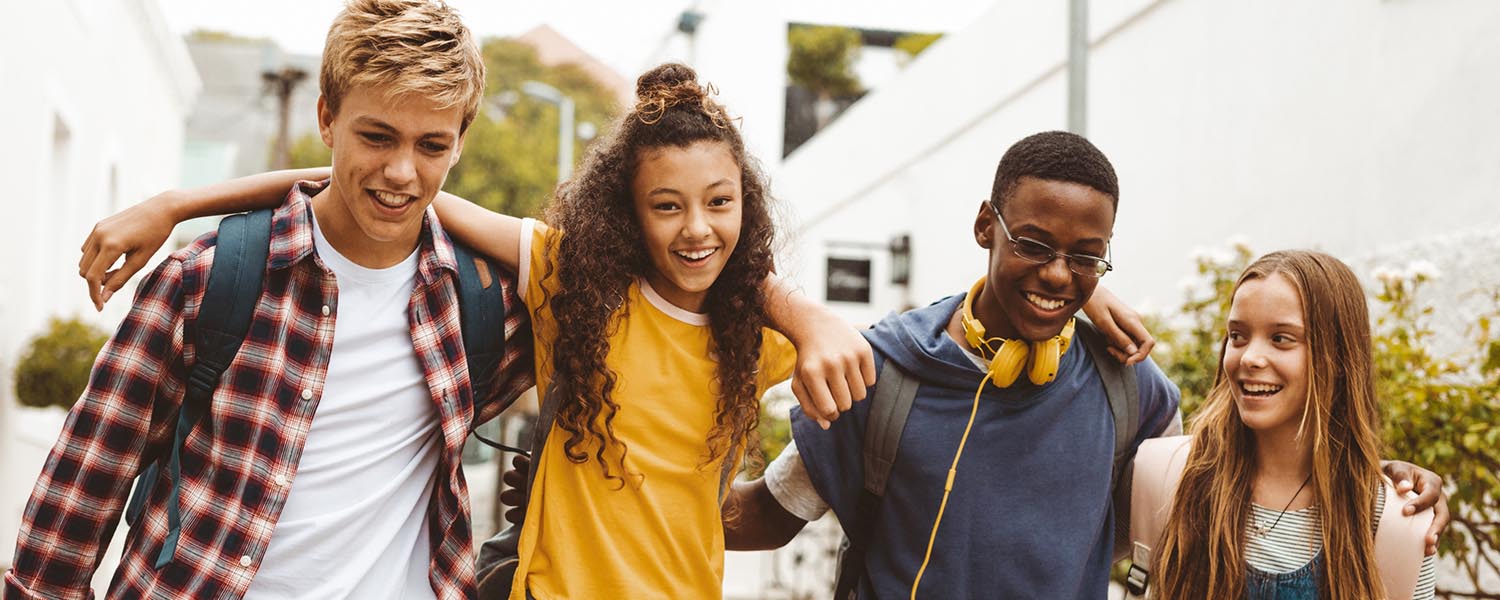 Four teens arm in arm