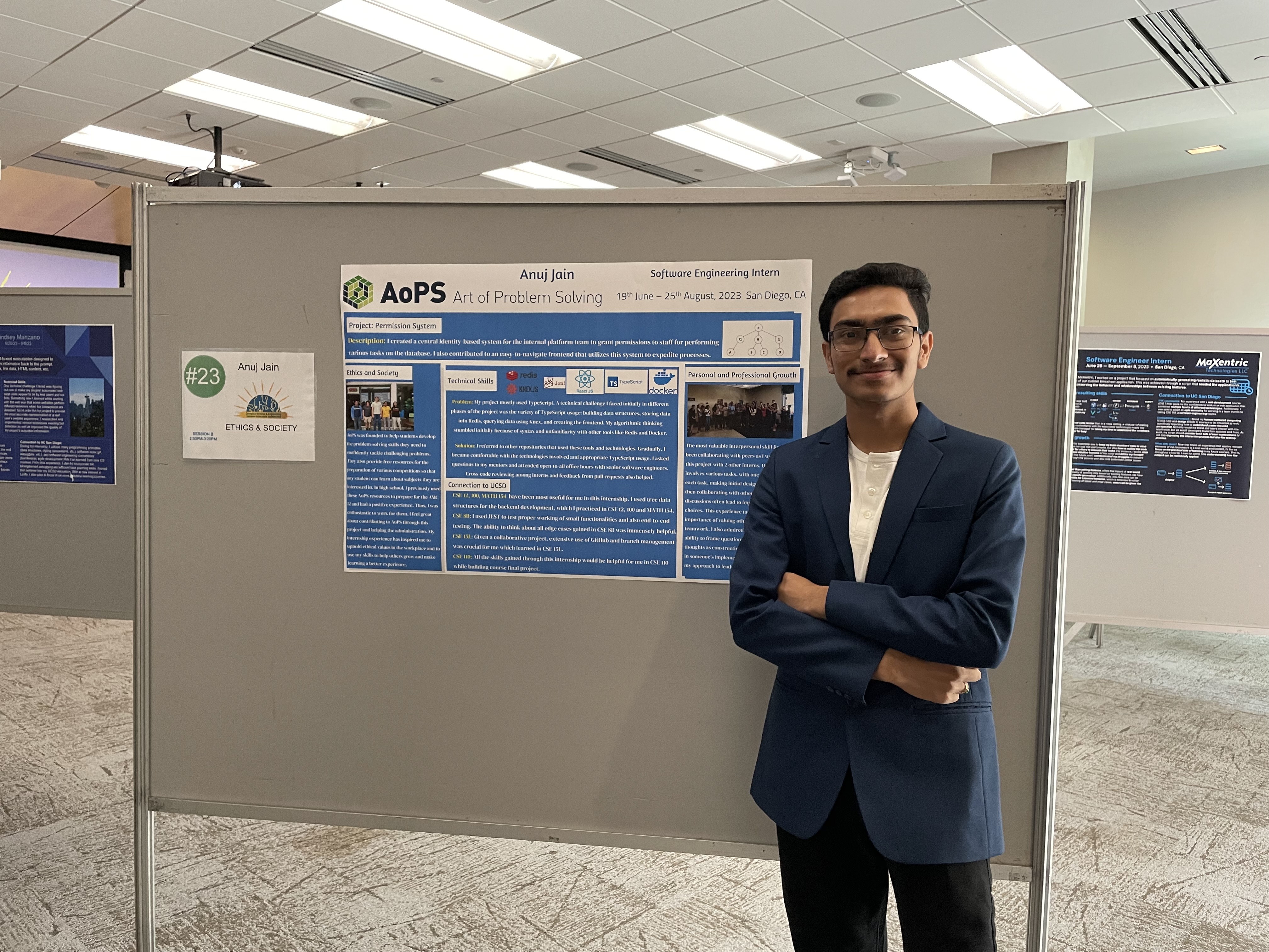 Student stands in front of poster presentation