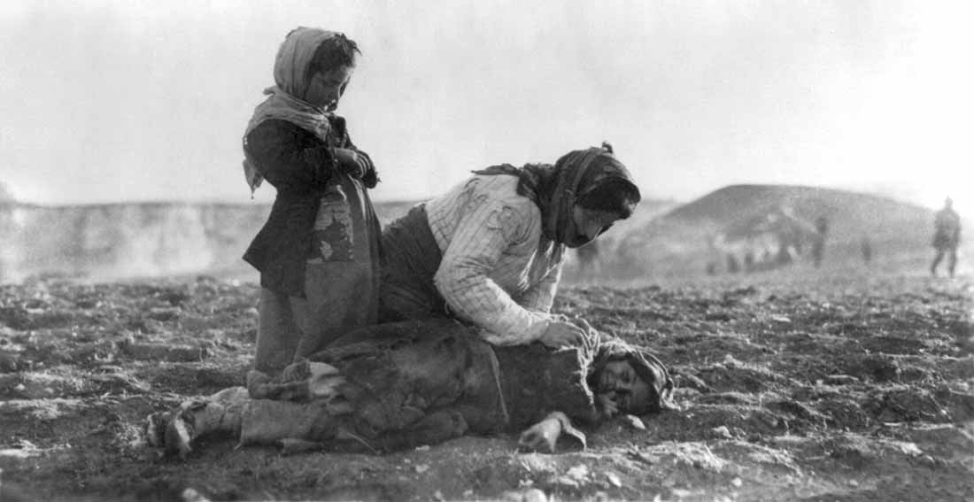 Image: Armenian woman kneeling beside dead children in field