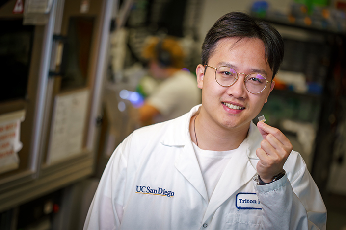 Sai Zhou, one of the study's co-first authors, holds the re-engineered wearable ultrasound patch.