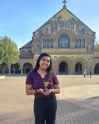 Arlene Nagtalon pictured holding a trophy on the Stanford campus.