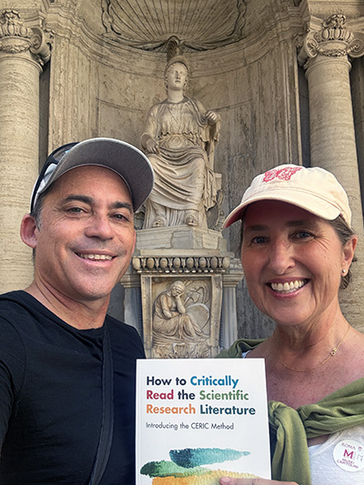 Burgasser and Bjorn holding up book while in Rome
