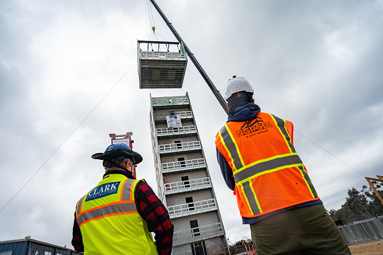 Picture of the building topping off with a crane