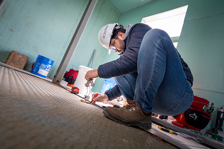Picture of a Ph.D. student installing sensors