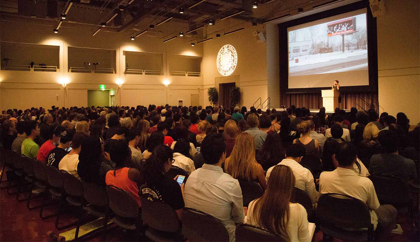 Image: An attentive audience listens to alumna Carrie Mae Weems