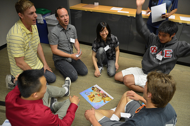 Joshua Yang celebrates as his group finishes a puzzle as part of a team-building exercise for incoming Calit2 Scholars.