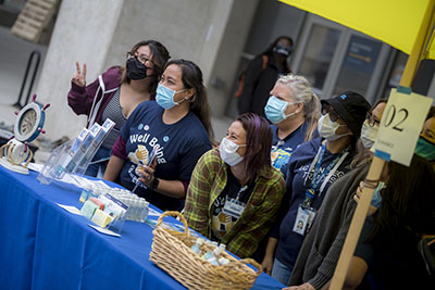 A group of UC San Diego staff posing for a group photo during a wellness fair.