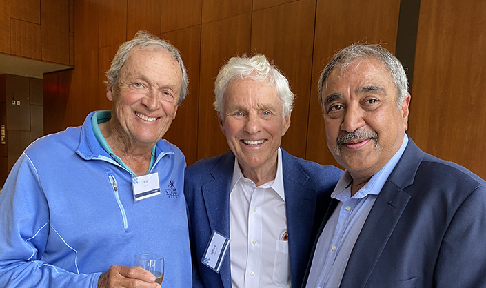 Three men smiling at the camera