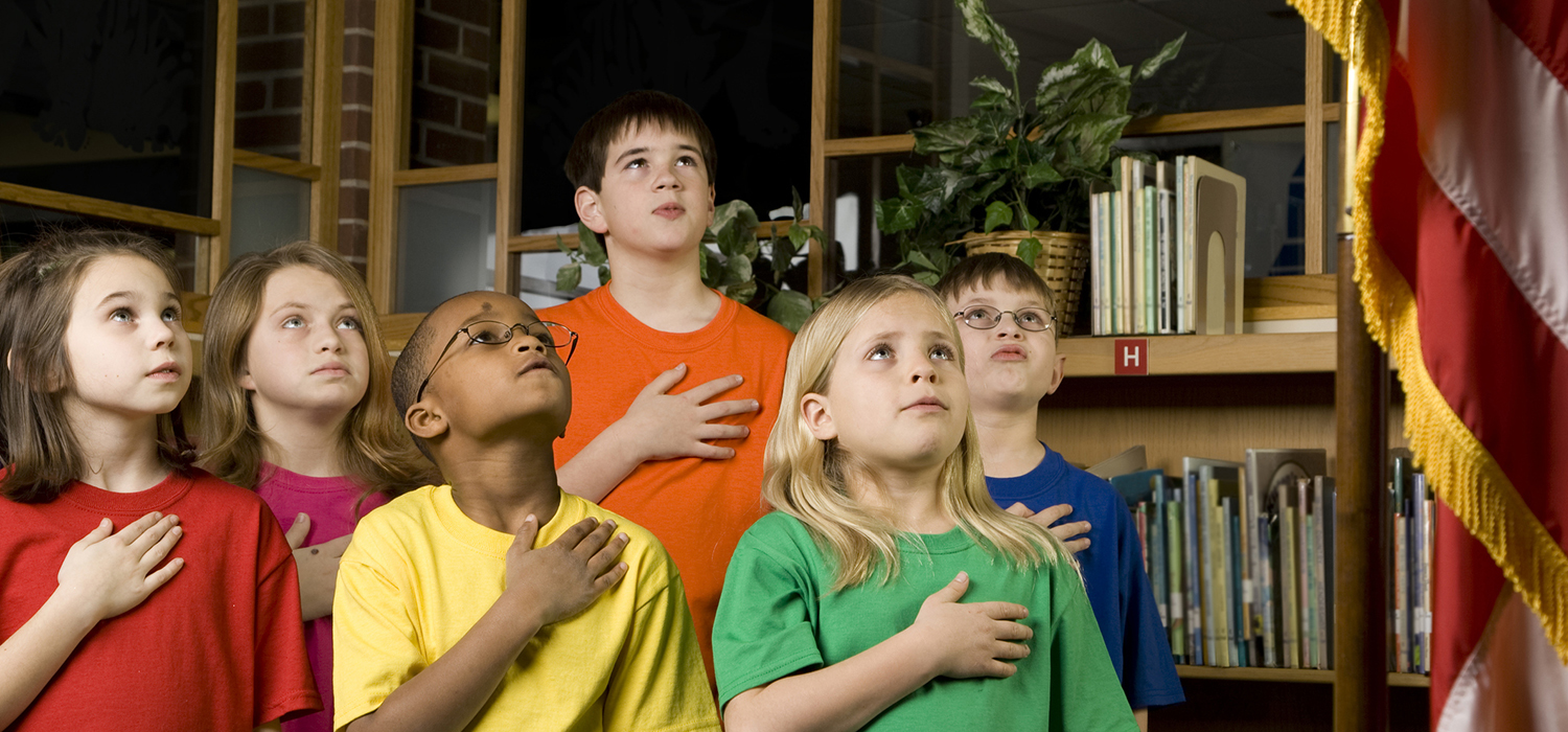 Classroom kids pledge allegiance to the flag