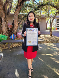 Frances Contreras with the proclamation declaring December 17