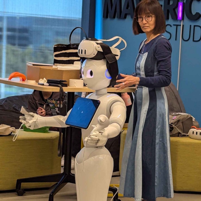 Amy Eguchi stands with life-sized robot