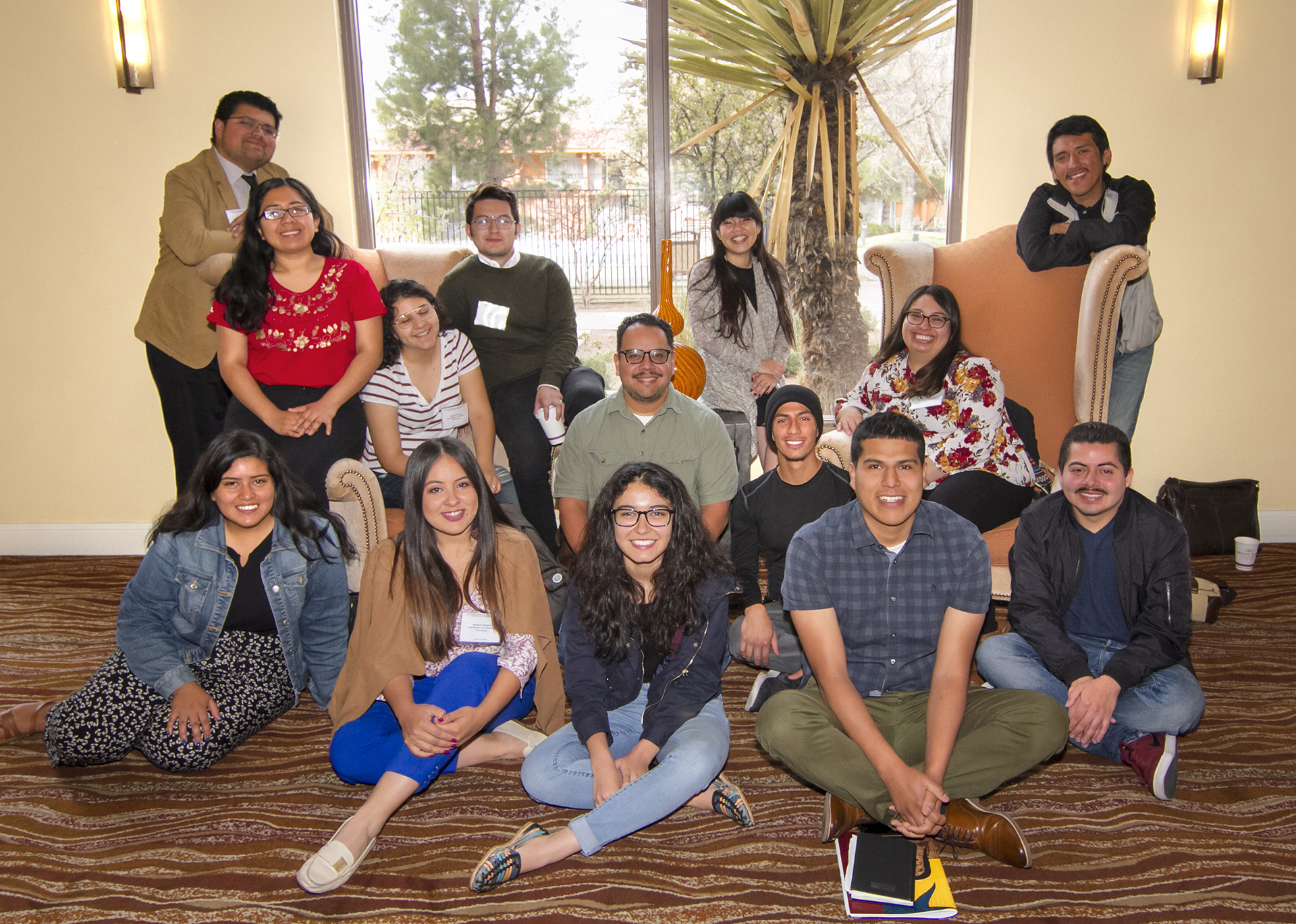 Gerardo Arellano sits in the middle of a group of scholars during a conference