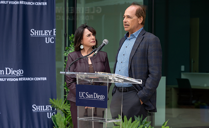 Man and woman at podium