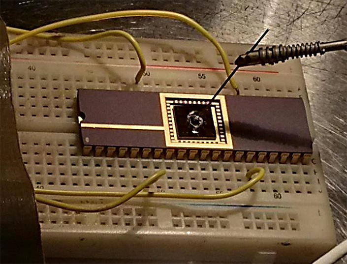 Electronic chip mounted on a platform with wires.