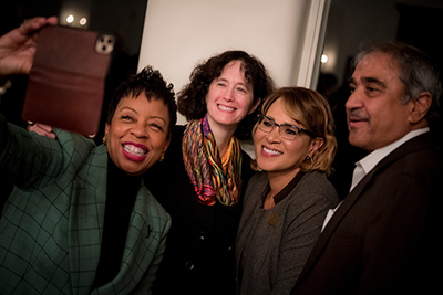 Helen Griffith, executive director of The Preuss School UC San Diego, holds her cell phone up to take a selfie with UC San Diego Executive Vice Chancellor Elizabeth Simmons, Vice Chancellor Becky Petitt and Chancellor Khosla at her welcome celebration.