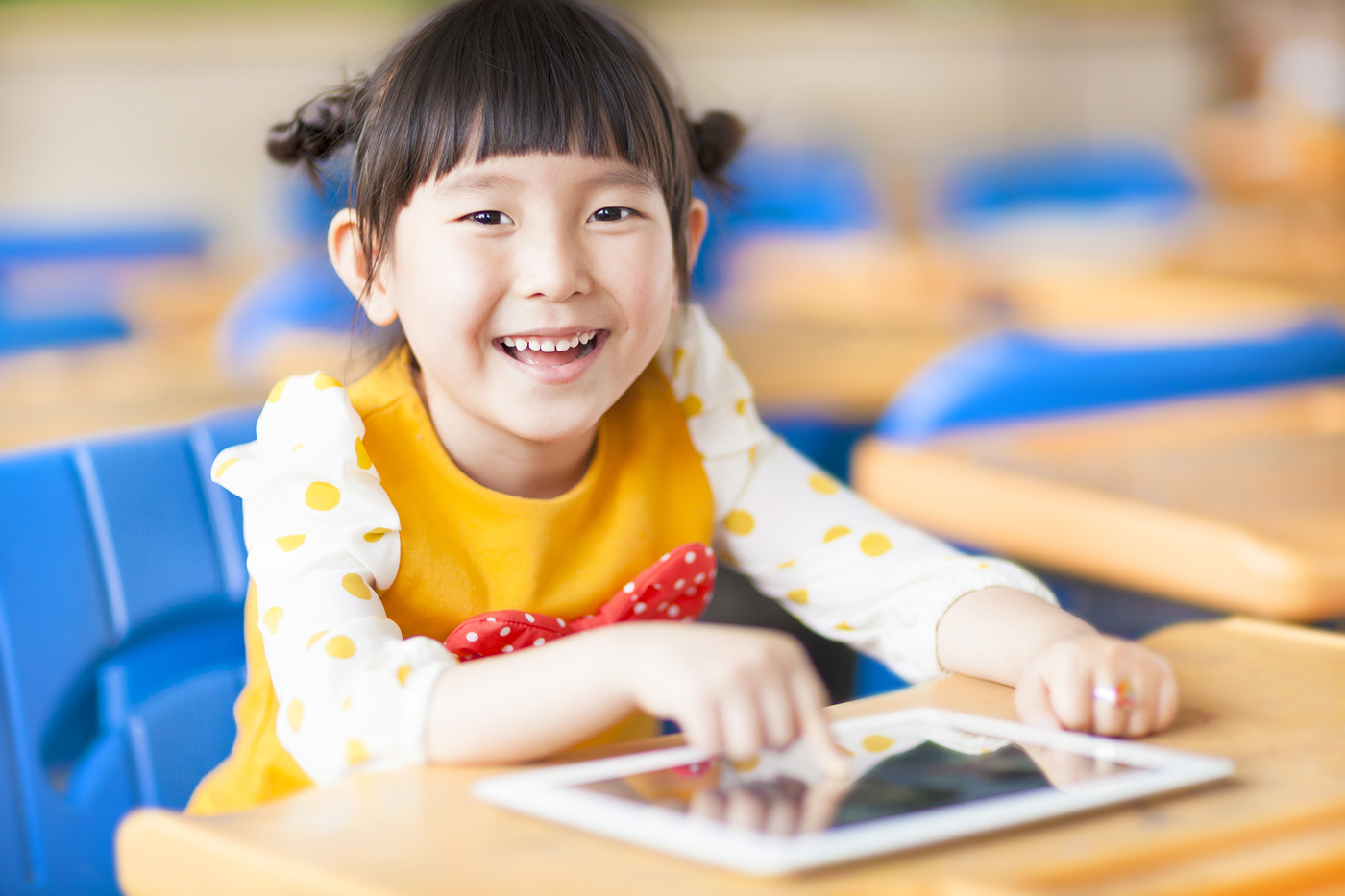 Happy girl on tablet