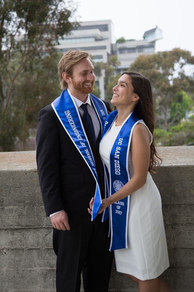Couple wearing graduation sashes