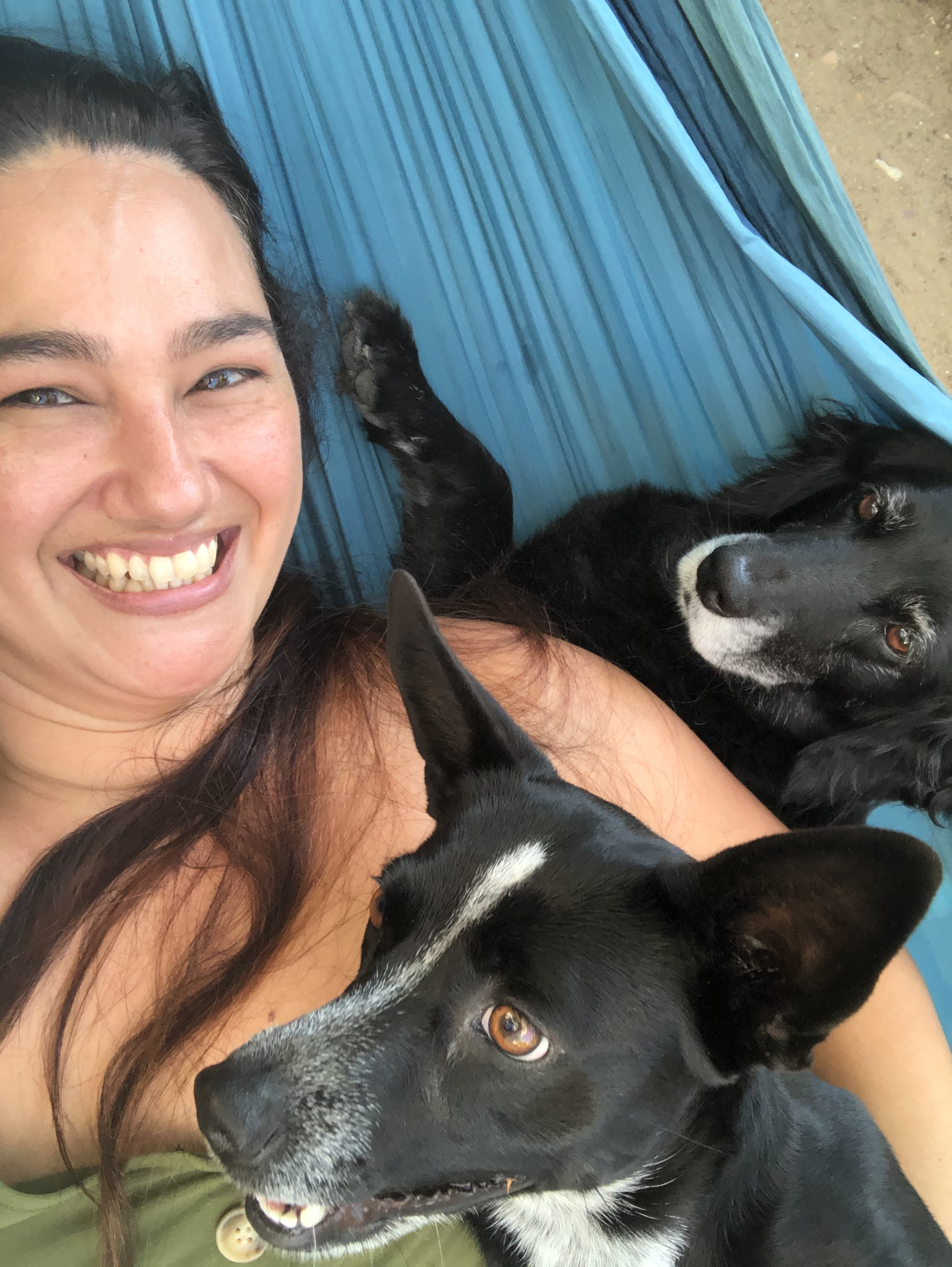 Eva with two dogs in a hammock