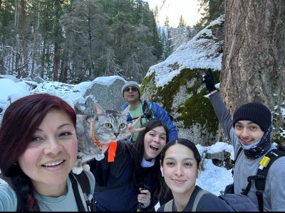 Rios smiling with family at Yosemite National Park
