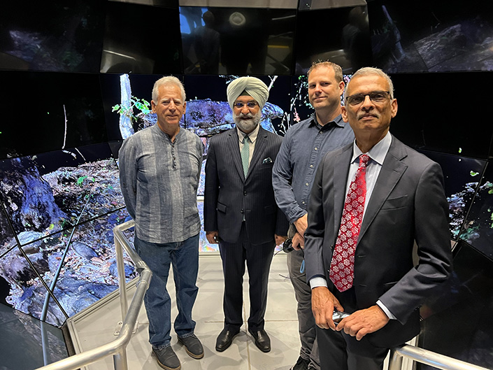 Researchers stand with Indian Ambassador to the U.S. inside the SunCAVE, a walk-in virtual reality facility, in Atkinson Hall.