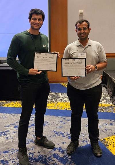 Nagarjun Bhat and Ishan Bansal pose with their best paper award