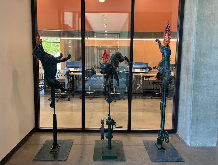 Photo of three statues of dogs with glass fire