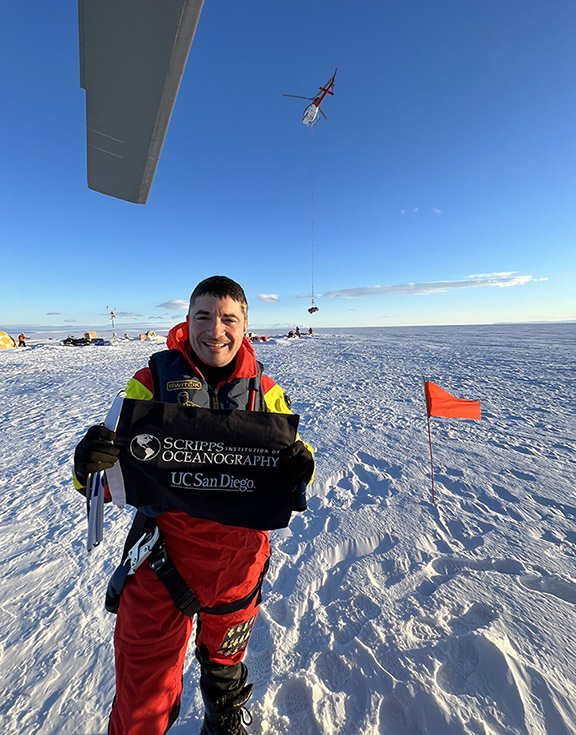 Scientist holding flag in Antarctica