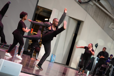 Dancer kicks his leg in the air.