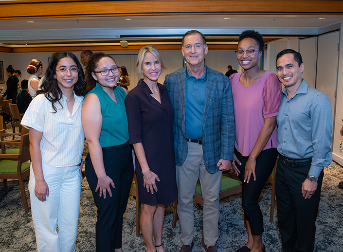 Amy and Bill Koman with scholarship recipients