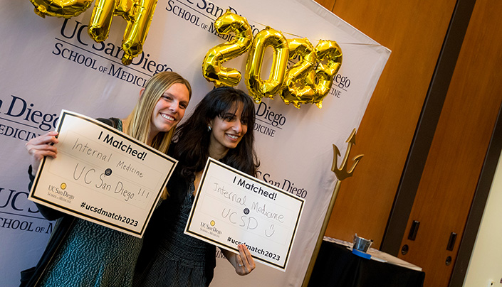 Students pose with their Match Day signs.