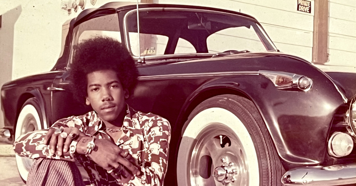Nathan East sits in front of his sports car