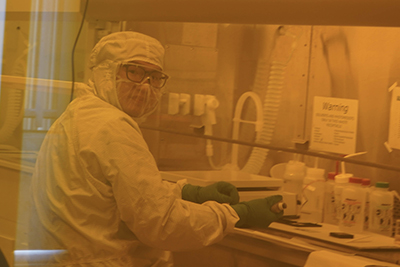 Person in cleanroom at bench