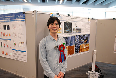 Liya Bi stands in front of his research poster