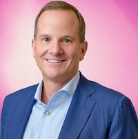 Photo of smiling man with suit and pink background