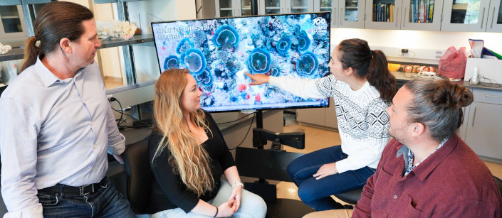 Team gathers around 3D coral model in Sandin Lab