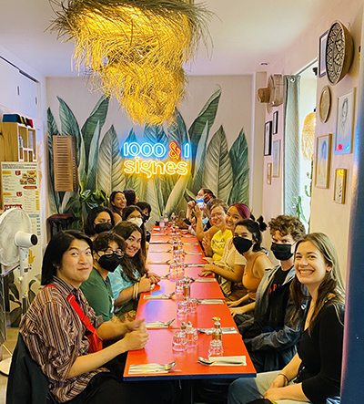 Group having lunch at long red table